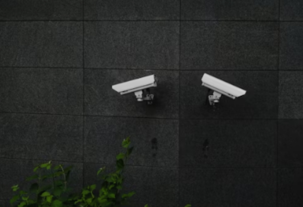 two security cameras mounted on the wall