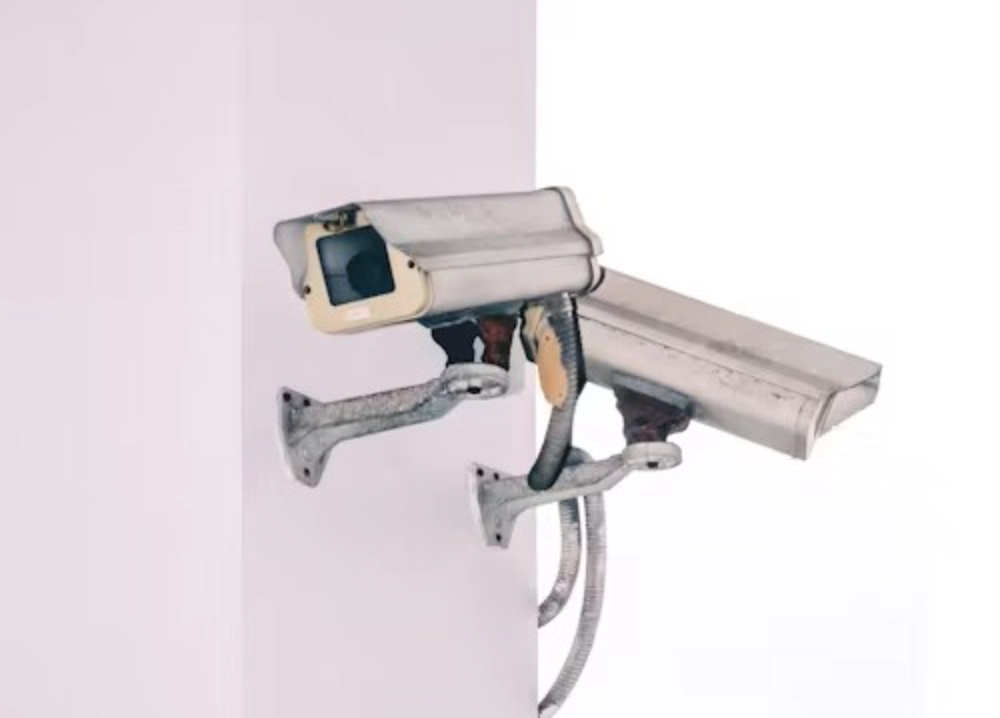 two white security cameras