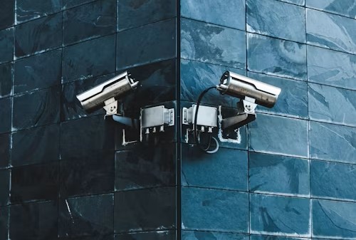 two surveillance cameras on the wall