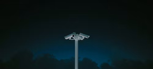 surveillance cameras facing three directions in the dark